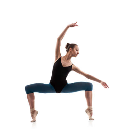 beautiful woman ballet dancer posing, isolated over white backgroundの写真素材