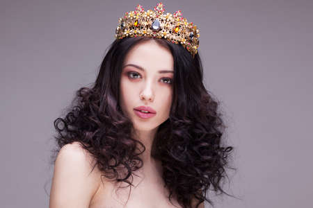Fashion shot of a woman with diadem and red lipstickの写真素材