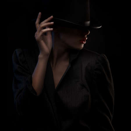 closeup portrait of elegant blond retro woman in hat over dark backgroundの写真素材
