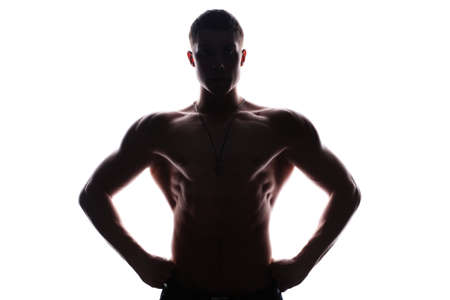 Silhouette of young athlete bodybuilder man isolated over white backgroundの写真素材