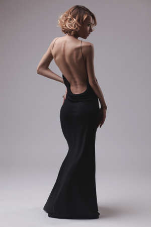 beautiful woman model posing in elegant dress on the grey studio backgroundの写真素材