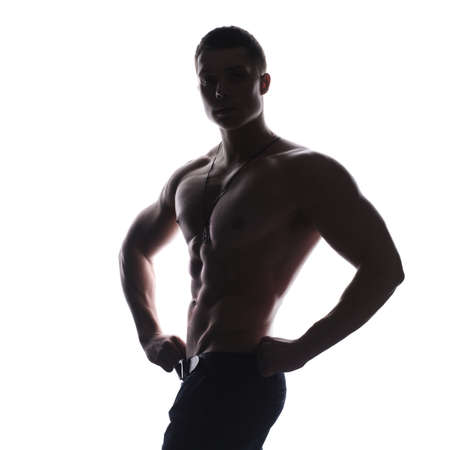 Silhouette of young athlete bodybuilder man isolated over white backgroundの写真素材
