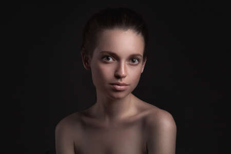 closeup studio portrait of beautiful woman isolated over dark backgroundの写真素材