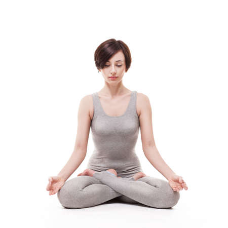 young beautiful woman yoga posing on isalated white studio backgroundの写真素材