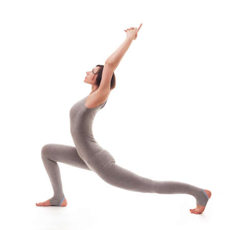 young beautiful woman yoga posing on isalated white studio backgroundの写真素材