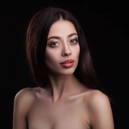 closeup fashion studio portrait of beautiful woman isolated over dark backgroundの写真素材