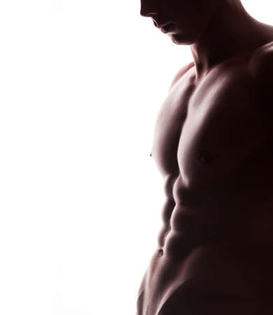 closeup of strong athletic mans torso with copyspase on white backgroundの写真素材