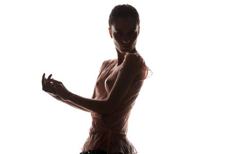 A silhouette of a woman in transparent blouse isolated on white backgroundの写真素材