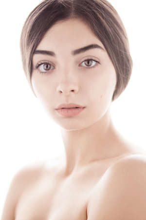 closeup portrait of young woman with clean fresh skin isolated on white backgroundの写真素材