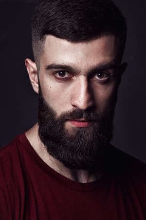closeup portrait of a bearded man on dark backgroundの写真素材