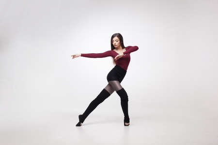 young woman dancer in maroon swimsuit posingの写真素材