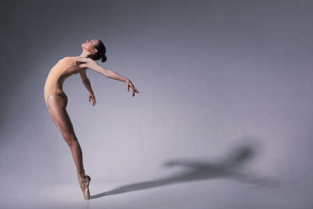 young beautiful ballet dancer in beige swimsuitの写真素材