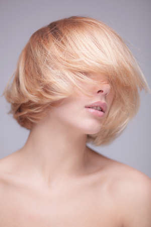 studio shot of beautiful young blond womanの写真素材