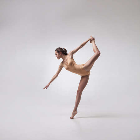 young beautiful ballet dancer in beige swimsuitの写真素材