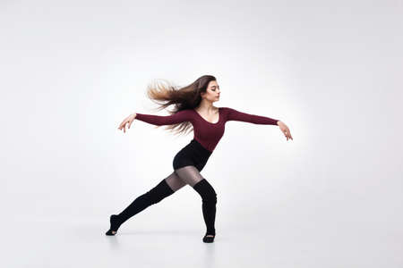 young woman dancer in maroon swimsuit posingの写真素材