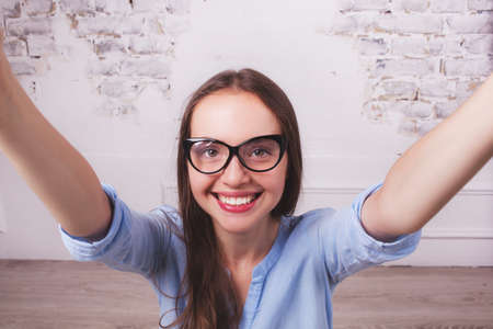 selfie-portrait of attractive girl in glasses