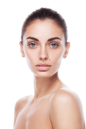 closeup portrait of young adult woman with clean fresh skin isolatedの写真素材
