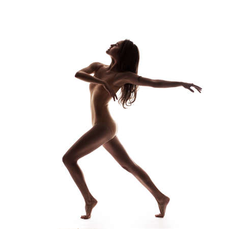 young beautiful dancer in beige swimsuit posingの写真素材