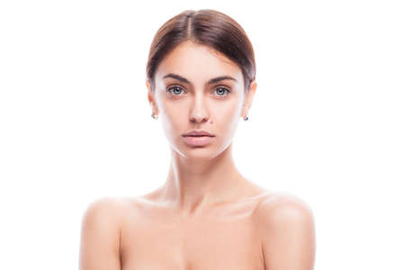 closeup portrait of young adult woman with clean fresh skin isolatedの写真素材