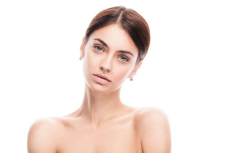closeup portrait of young adult woman with clean fresh skin isolatedの写真素材