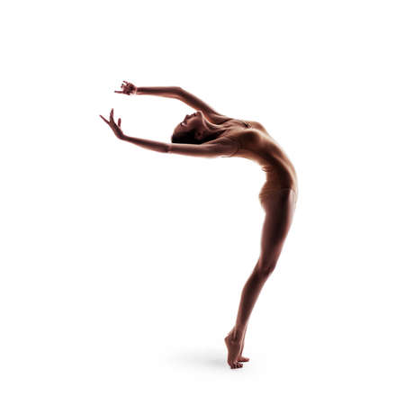 young beautiful dancer in beige swimsuit posingの写真素材