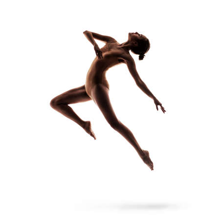 young beautiful dancer in beige swimsuit posingの写真素材