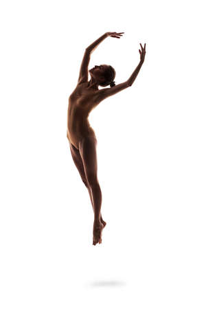 young beautiful dancer in beige swimsuit posingの写真素材