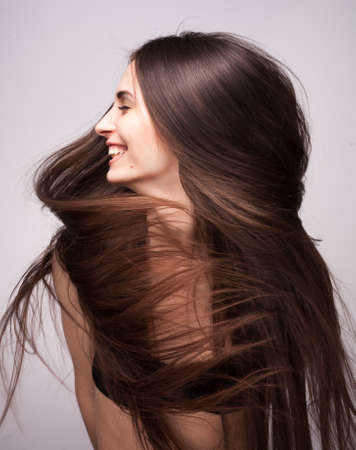beautiful woman with long flying hairの写真素材