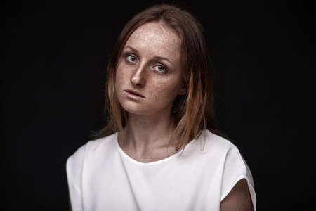 closeup studio portrait of freckled woman without makeupの写真素材