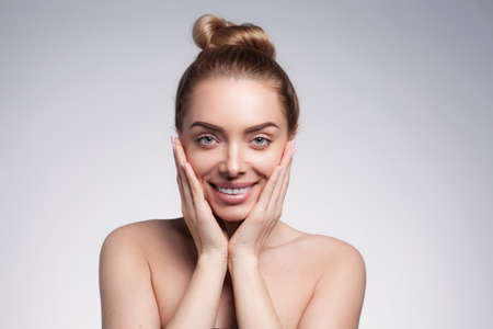 closeup portrait of beautyful blond smiling woman with clean fresh skinの写真素材