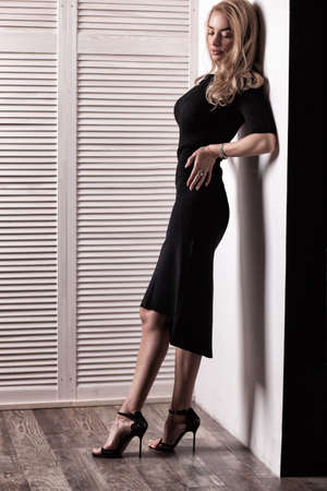 beautiful woman model posing in elegant black dressの写真素材