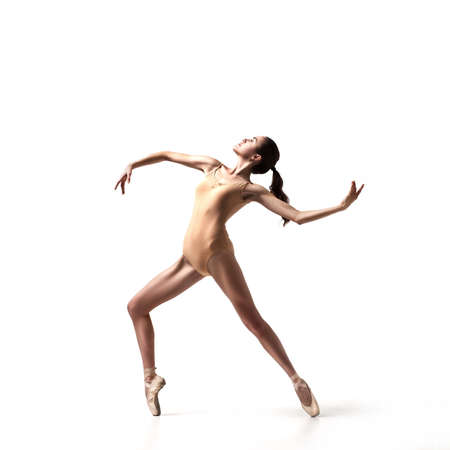 young beautiful dancer in beige swimsuitの写真素材