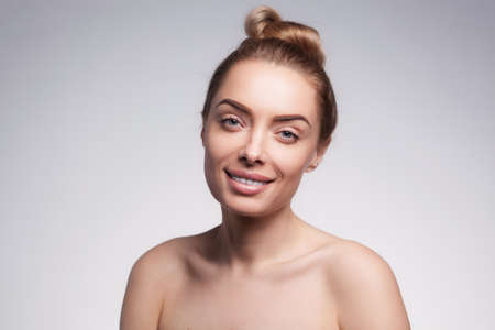 closeup portrait of beautyful blond smiling woman with clean fresh skinの写真素材