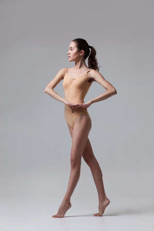 young beautiful dancer in beige swimsuitの写真素材
