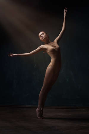 young beautiful ballet dancer in beige swimsuitの写真素材