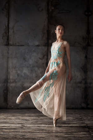 young beautiful ballet dancer in beige dressの写真素材