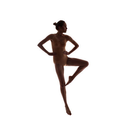 young beautiful dancer in beige swimsuit posingの写真素材