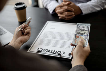A business partner representative meets a procurement manager offering large sums of money as a...