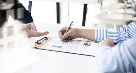 The HR department is reviewing the resumes of job applicants, resumes are important documents for job application. It should contain resume, training history, education, talent, work skills, etc.の写真素材