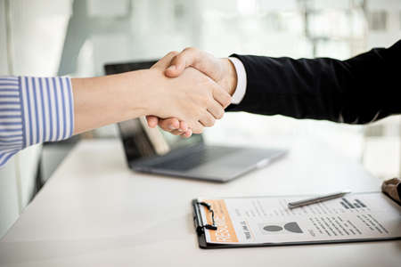 Managers and job applicants are handshaking each other after the interview has been completed, shaking hands to congratulate them after the job interview and recruiting candidates.の写真素材