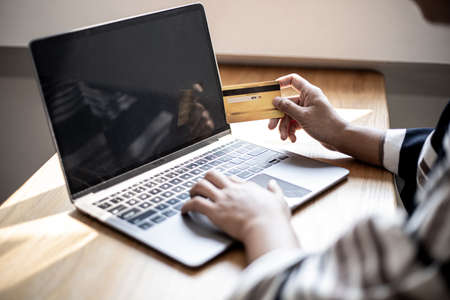 Women are filling out their credit card information to pay for purchases made through the website. Credit cards can pay for goods and services online. Online shopping ideasの写真素材