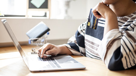 Women are filling out their credit card information to pay for purchases made through the website. Credit cards can pay for goods and services online. Online shopping ideasの写真素材