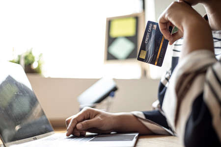 Women are filling out their credit card information to pay for purchases made through the website. Credit cards can pay for goods and services online. Online shopping ideasの写真素材