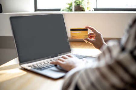 Women are filling out their credit card information to pay for purchases made through the website. Credit cards can pay for goods and services online. Online shopping ideasの写真素材