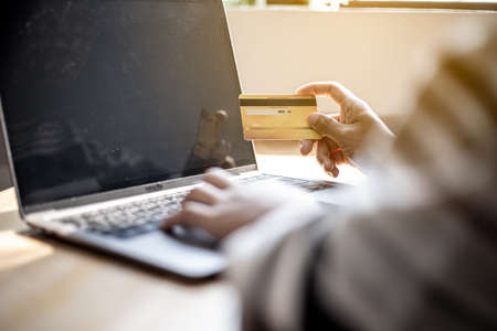 Women are filling out their credit card information to pay for purchases made through the website. Credit cards can pay for goods and services online. Online shopping ideasの写真素材