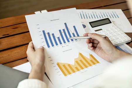 Company finance staff preparing financial documents, company finance staff preparing company finance documents to bring to the meeting to summarize for management's acknowledgment. Financial concept.の写真素材