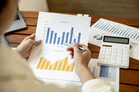 Company finance staff preparing financial documents, company finance staff preparing company finance documents to bring to the meeting to summarize for management's acknowledgment. Financial concept.の写真素材