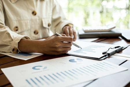 Company finance staff preparing financial documents, company finance staff preparing company finance documents to bring to the meeting to summarize for management's acknowledgment. Financial concept.の写真素材