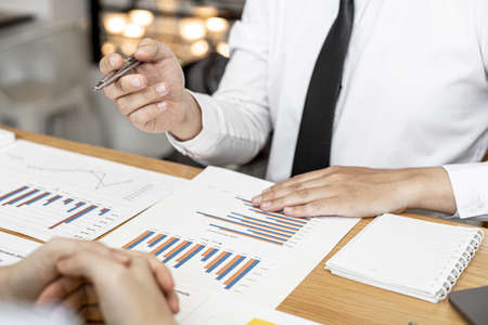 Finance staff are presenting financial information to finance managers by documenting charts, providing financial information to plan and develop the company's finances to grow. Financial concept.の写真素材