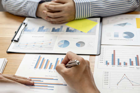 Finance staff is preparing company financial documents, data sheets in the form of charts as the company's financial, sales and expenditures to be brought into the meeting. Financial concept.の写真素材